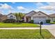 A charming, single-story house features a lush green lawn and a manicured shrubbery at 12137 Dickenson Ln, Orlando, FL 32821