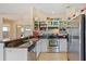 Bright kitchen featuring tile floors, stainless steel appliances and black countertops at 12137 Dickenson Ln, Orlando, FL 32821