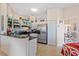 Bright kitchen featuring tile floors, stainless steel refrigerator and black countertops at 12137 Dickenson Ln, Orlando, FL 32821