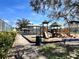 View of playground and covered picnic areas, with mature trees and a smooth walking path at 12137 Dickenson Ln, Orlando, FL 32821