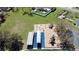 Aerial view of community playground with slides and play structures on wood chips and picnic area at 12137 Dickenson Ln, Orlando, FL 32821