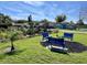 Blue benches create a cozy outdoor sitting area, nestled in a community green space perfect for relaxation at 12137 Dickenson Ln, Orlando, FL 32821