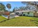 Spacious backyard featuring a pool, patio furniture, and lush green lawn at 1525 Orange Tree Dr, Edgewater, FL 32132