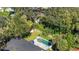 Aerial view of a private backyard oasis with a refreshing pool, lush landscaping, and space for entertaining at 1525 Orange Tree Dr, Edgewater, FL 32132