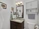 Bathroom featuring a single sink, a granite countertop, and a mirror above the sink at 1525 Orange Tree Dr, Edgewater, FL 32132