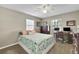 Bedroom with carpet floors, a double bed, a ceiling fan, and lots of natural light at 1525 Orange Tree Dr, Edgewater, FL 32132