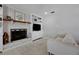 Comfortable living room featuring a fireplace with white brick surround and built in shelving at 1525 Orange Tree Dr, Edgewater, FL 32132