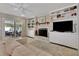 Cozy living room with built-in shelving, fireplace, and sliding doors to the patio at 1525 Orange Tree Dr, Edgewater, FL 32132