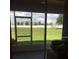 View of a large backyard from an enclosed back porch at 1560 Chelsea Dr, Davenport, FL 33897