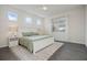 Bright bedroom featuring a white bed frame, tiled flooring, and a neutral-toned accent rug at 16410 Taliesin St, Winter Garden, FL 34787