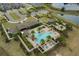 Aerial view of the community pool and clubhouse, complete with palm trees and lounge chairs at 16410 Taliesin St, Winter Garden, FL 34787