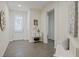 Bright foyer features tile flooring, a white front door, and decorative accents, creating a welcoming entrance at 16410 Taliesin St, Winter Garden, FL 34787