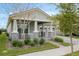 Inviting home exterior highlighting the covered front porch, stone accents, well-maintained landscaping, and a two-car garage at 16410 Taliesin St, Winter Garden, FL 34787