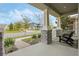 Relaxing front porch view with comfortable seating and decorative columns, perfect for enjoying the neighborhood scenery at 16410 Taliesin St, Winter Garden, FL 34787