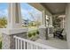 Inviting front porch showcasing stylish columns, a cozy seating area, and a welcoming view of the neighborhood at 16410 Taliesin St, Winter Garden, FL 34787