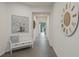 Hallway features tile flooring, neutral walls, and decorative accents, leading to the home's living areas at 16410 Taliesin St, Winter Garden, FL 34787