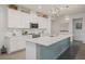 Contemporary kitchen featuring white cabinetry, quartz countertops, and a stylish island with pendant lighting at 16410 Taliesin St, Winter Garden, FL 34787