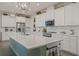 Modern kitchen featuring white cabinets, a spacious island, stainless steel appliances, and ample counter space at 16410 Taliesin St, Winter Garden, FL 34787