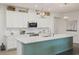 Contemporary kitchen featuring white cabinetry, quartz countertops, and a stylish island with pendant lighting at 16410 Taliesin St, Winter Garden, FL 34787