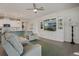 Comfortable living room featuring a built-in entertainment center, tile flooring, and open access to the kitchen at 16410 Taliesin St, Winter Garden, FL 34787