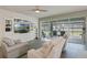 Inviting living room featuring a built-in media center, tile flooring, and sliding glass doors that offer backyard views at 16410 Taliesin St, Winter Garden, FL 34787