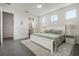 Open main bedroom showing tiled floor, accent rug, and ensuite bathroom with natural light and neutral decor at 16410 Taliesin St, Winter Garden, FL 34787