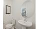 Stylish powder room featuring a pedestal sink, oval mirror, and decorative artwork at 16410 Taliesin St, Winter Garden, FL 34787