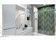 Modern bathroom featuring a sleek vanity, decorative shower with glass doors, and bright window at 166 Hammock Preserve Loop, Winter Garden, FL 34787