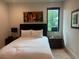 Bedroom featuring an accent skyline painting, gold animal statue and a light colored area rug at 166 Hammock Preserve Loop, Winter Garden, FL 34787