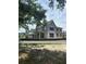 Two-story home exterior under construction with covered patio, featuring nearby houses in a residential area at 166 Hammock Preserve Loop, Winter Garden, FL 34787