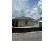 Single-story home exterior under construction features visible blocks and wood framing in a sunny neighborhood at 166 Hammock Preserve Loop, Winter Garden, FL 34787
