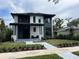 Modern two-story home with clean lines, dark accents, and a well-manicured lawn at 166 Hammock Preserve Loop, Winter Garden, FL 34787