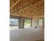 View of garage under construction with concrete flooring and exposed wooden ceiling framework at 166 Hammock Preserve Loop, Winter Garden, FL 34787