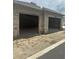 Close-up of the concrete block garage structure, highlighting its spacious layout and unfinished construction at 166 Hammock Preserve Loop, Winter Garden, FL 34787