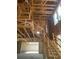 An in-construction interior view highlighting the exposed wooden frame, stairs, and high ceiling at 166 Hammock Preserve Loop, Winter Garden, FL 34787