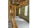 View of a framed room with windows in a building under construction, highlighting the concrete flooring and cinder block walls at 166 Hammock Preserve Loop, Winter Garden, FL 34787