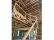 View of interior framing showing exposed wood beams and a staircase leading to the upper level at 166 Hammock Preserve Loop, Winter Garden, FL 34787