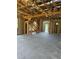 An in-construction interior with open floor plan and exposed wooden frame and stairs at 166 Hammock Preserve Loop, Winter Garden, FL 34787