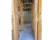 View of a framed hallway in a building under construction, highlighting the concrete flooring and cinder block walls at 166 Hammock Preserve Loop, Winter Garden, FL 34787