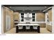 Modern kitchen with a large island, wood cabinetry, and sleek black and white finishes at 166 Hammock Preserve Loop, Winter Garden, FL 34787