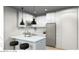 Compact kitchen featuring sleek white cabinetry, stainless steel appliances, and modern pendant lighting at 166 Hammock Preserve Loop, Winter Garden, FL 34787