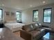 Open-concept living area with a comfortable couch and large windows at 166 Hammock Preserve Loop, Winter Garden, FL 34787