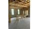View of a framed room with windows in a building under construction, highlighting the concrete flooring and cinder block walls at 166 Hammock Preserve Loop, Winter Garden, FL 34787
