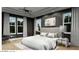 Serene main bedroom featuring dark walls, light wood floors, and elegant furnishings at 166 Hammock Preserve Loop, Winter Garden, FL 34787