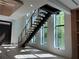 Modern staircase featuring floating wooden steps and an abundance of natural light at 166 Hammock Preserve Loop, Winter Garden, FL 34787