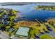 Stunning aerial view of tennis courts, playground, and dock, all with lake access at 17437 Promenade Dr, Clermont, FL 34711