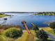 Panoramic aerial view of a gazebo with a dock on a serene lake, perfect for relaxation at 17437 Promenade Dr, Clermont, FL 34711