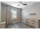 This bedroom features a ceiling fan, neutral walls, and wood-look floors at 17437 Promenade Dr, Clermont, FL 34711