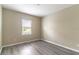 Bedroom featuring a window, light-colored walls, and gray vinyl plank flooring at 17437 Promenade Dr, Clermont, FL 34711