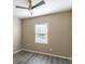 Cozy bedroom with a ceiling fan, window, and gray vinyl plank flooring at 17437 Promenade Dr, Clermont, FL 34711